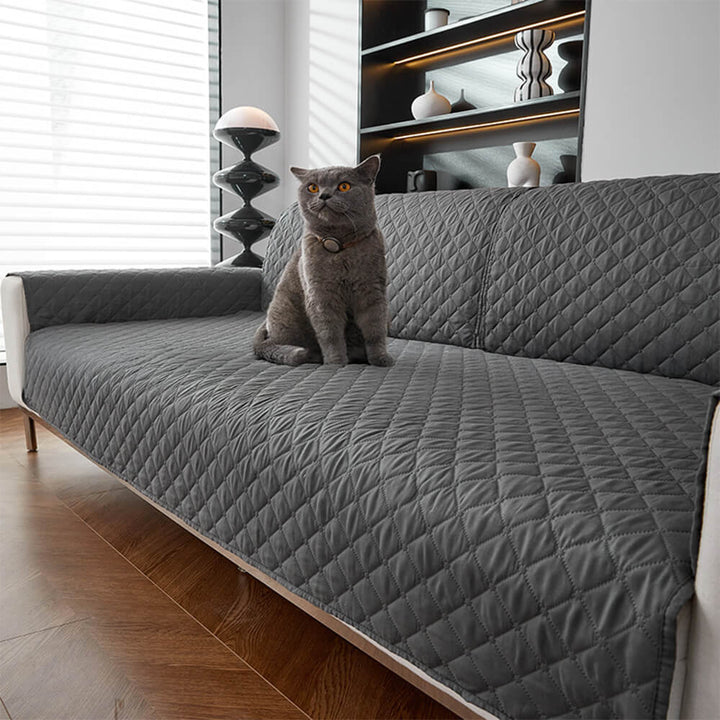 Beige pet-friendly sofa cover on a living room couch, offering waterproof furniture protection.