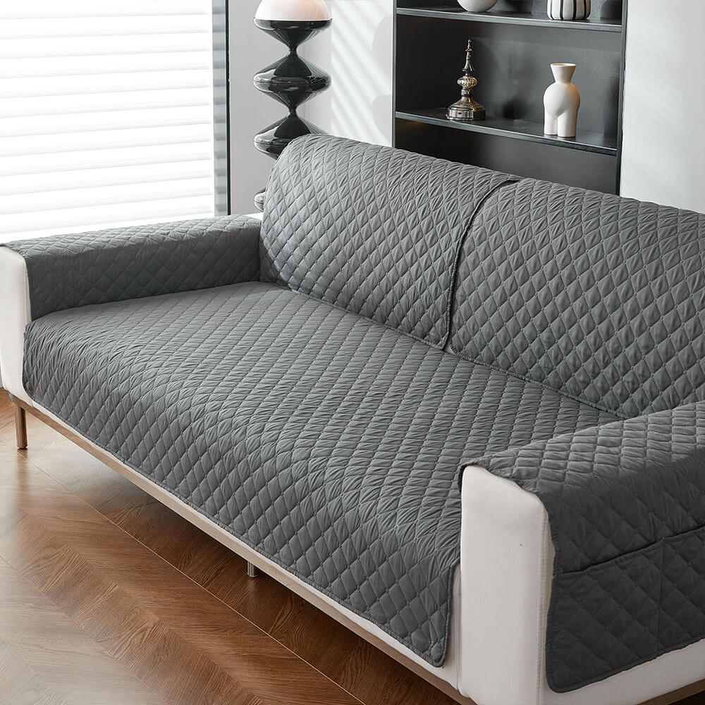 Gray waterproof couch cover with non-slip backing, ideal for homes with pets, easy to clean.