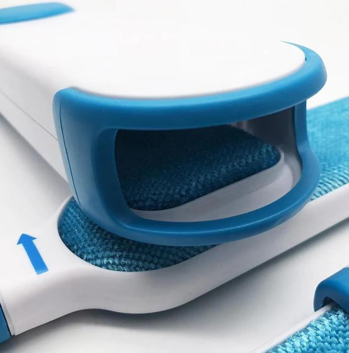 Hand holding pet hair remover tool, demonstrating ease of use on cushion for home cleaning