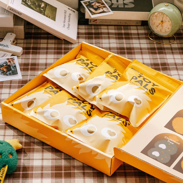 Children's hands unboxing the Pet Plush Squeaker Toy Box Set, exciting pet gifts for holidays.