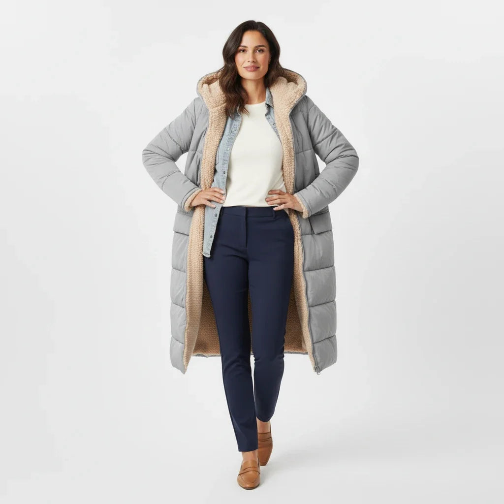 Long women's puffer coat, hooded and insulated for severe winter conditions.