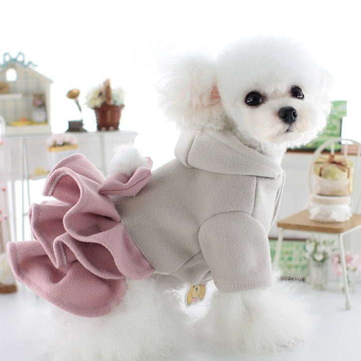 Close-up of a pink fleece dog dress jacket with an elegant bow, warm and stylish pet apparel