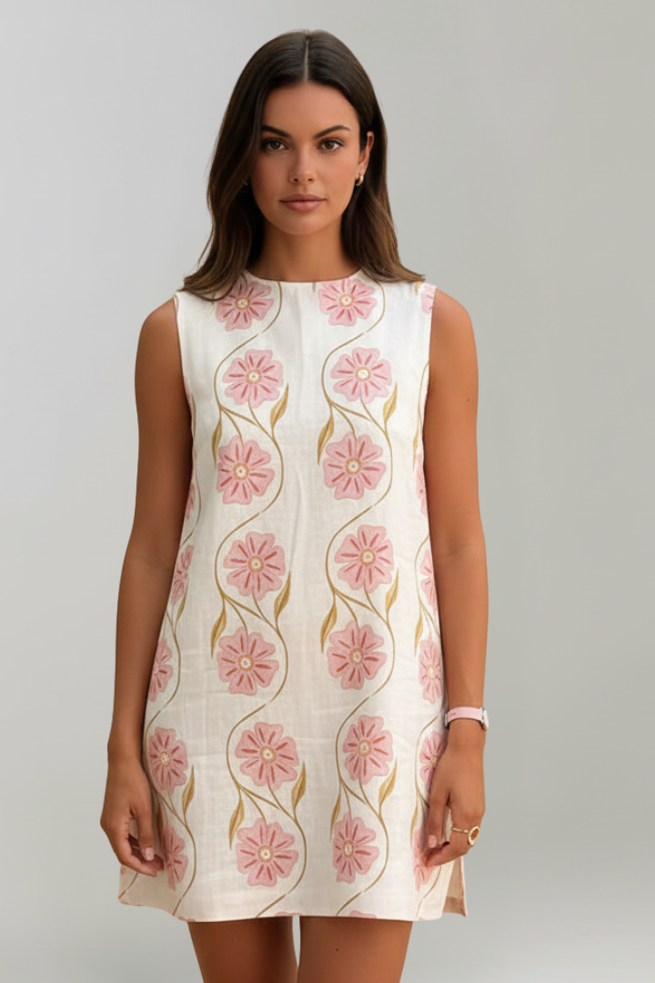 Effortless pink floral print mini dress for women. Sleeveless A-line summer fashion. Casual vacation wear.
