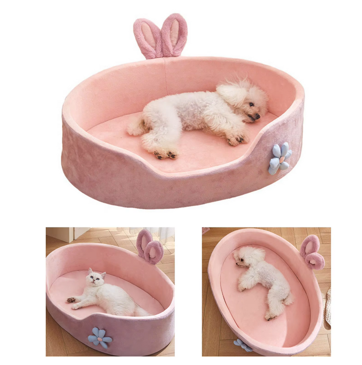 Stylish pink pet bed, a cozy haven for pets, complete with cute bunny ears and a flower decoration.