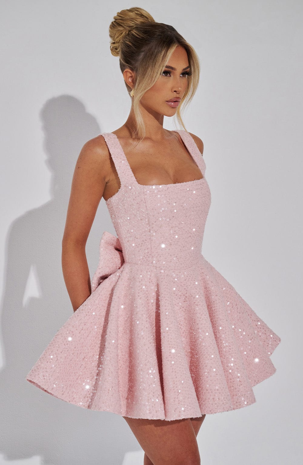 Shine bright in this pink sequin homecoming skater dress for women, complete with a beautiful bow.