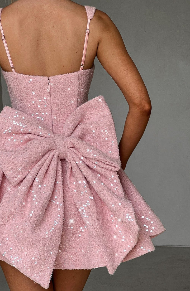 Sparkling pink sequin skater dress with a bow, a perfect women's party dress for special occasions.