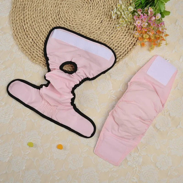 Close-up of pink washable dog diaper showing adjustable fasteners for female pets