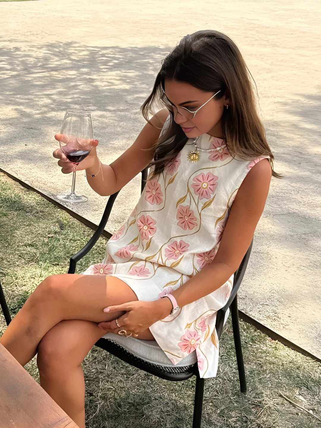 Pink women's A-line mini dress with floral pattern, mock neck, and sleeveless design for effortless summer style.