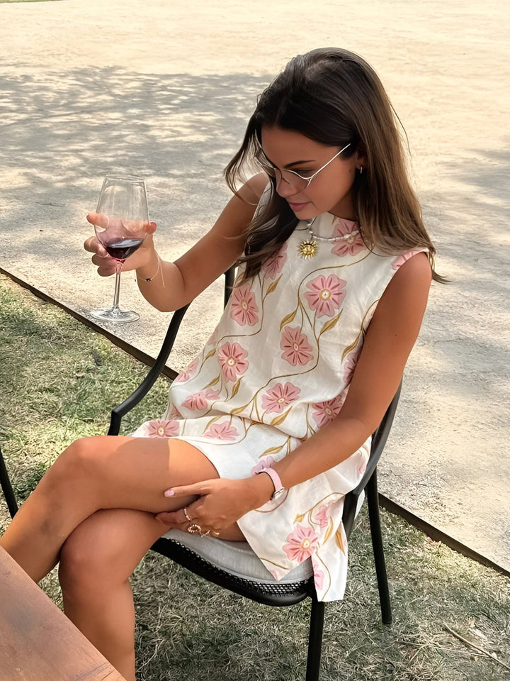 Pink women's A-line mini dress with floral pattern, mock neck, and sleeveless design for effortless summer style.