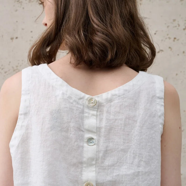 Comfortable women's relaxed fit crop top. Asymmetric hem, sleeveless. Perfect for modern summer casual fashion.