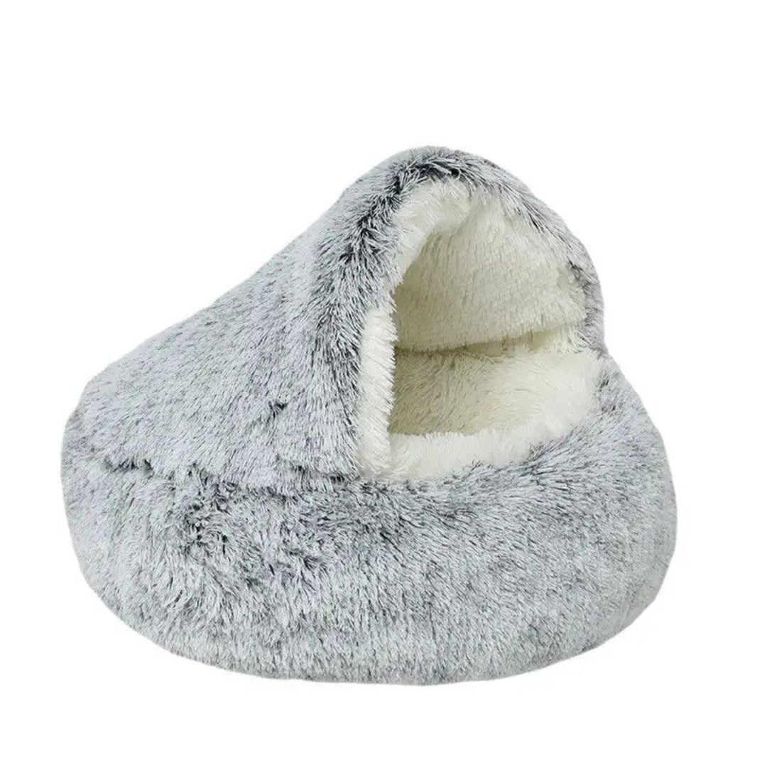 Pink calming pet bed for small dogs. Plush cave bed for deep sleep and anxiety relief.