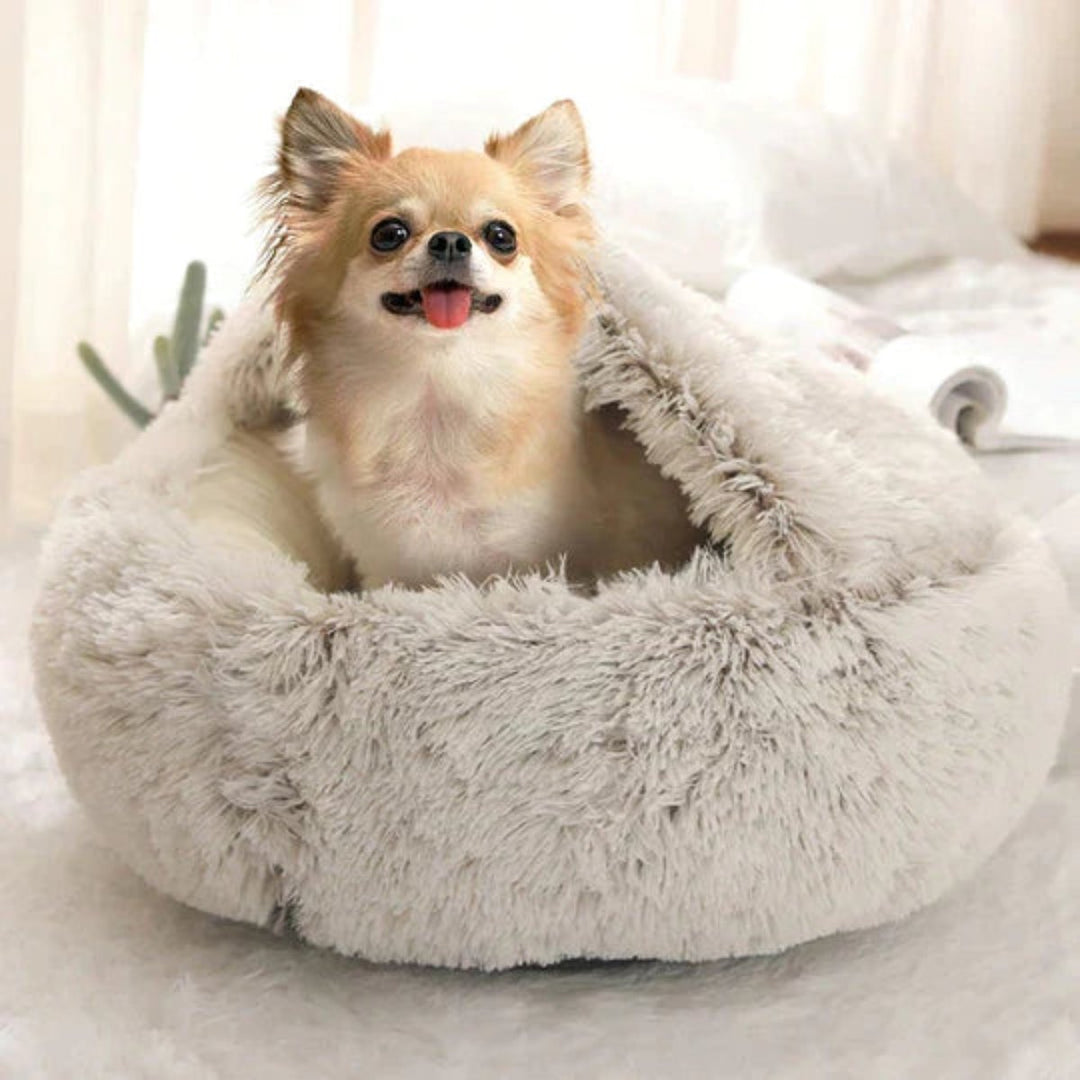 Beige round dog bed, a plush pet accessory for anxiety relief and comfortable deep sleep.