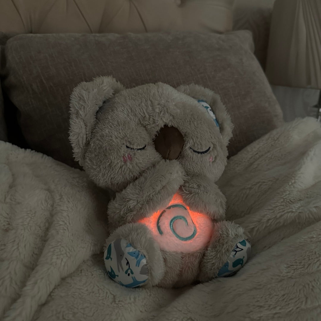 Soothing plush koala breathing toy with soft night light, providing comfort & relaxation for sleep.
