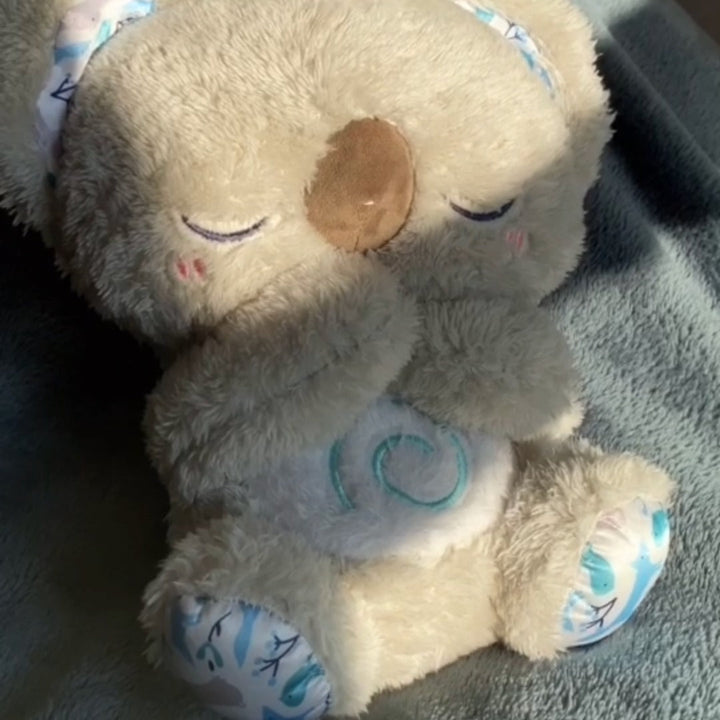 Child cuddling a plush calming koala breathing toy, finding stress relief & comfort, promoting relaxation.