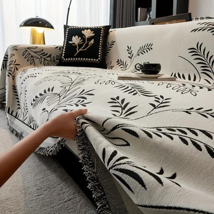 Textured chenille couch throw in a rich burgundy color, featuring stylish tassels for home decor.
