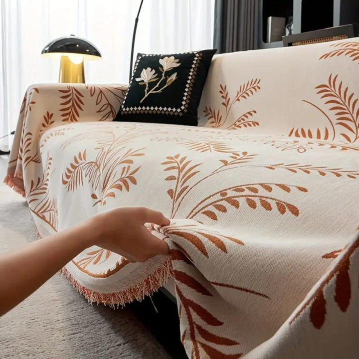 Close-up of soft chenille fabric and handcrafted tassels on a durable sofa cover, New4 model.