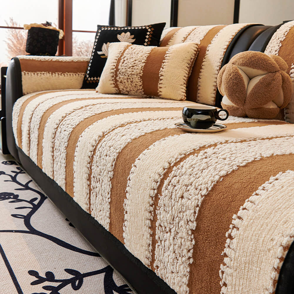 Overview of a plush chenille striped cover draped over a sofa, highlighting its thick fabric and non-slip design.