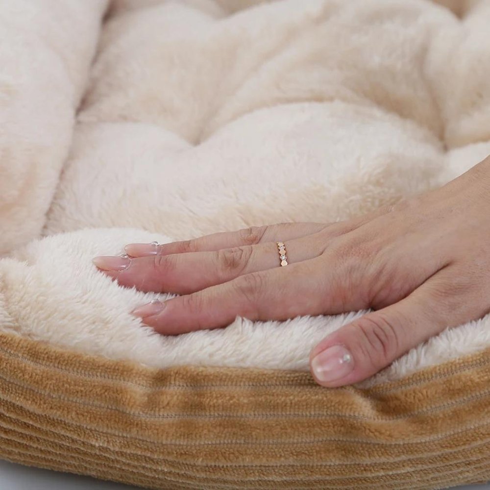 Soft, washable plush pet bed with a non-slip base, ensuring your dog's comfortable and secure sleep.