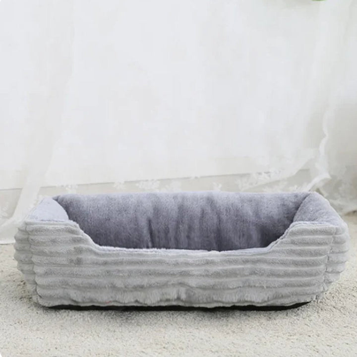 Durable, washable dog bed featuring a plush, cozy surface for maximum pet comfort and a non-slip bottom.