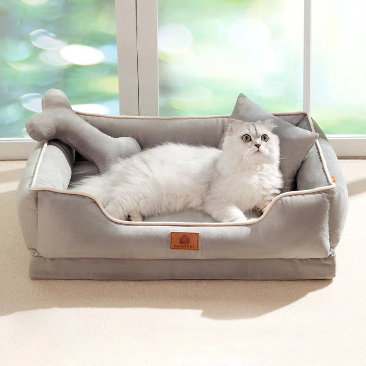 Square plush dog sofa bed in a living room, featuring a cozy design and washable bolster for pets