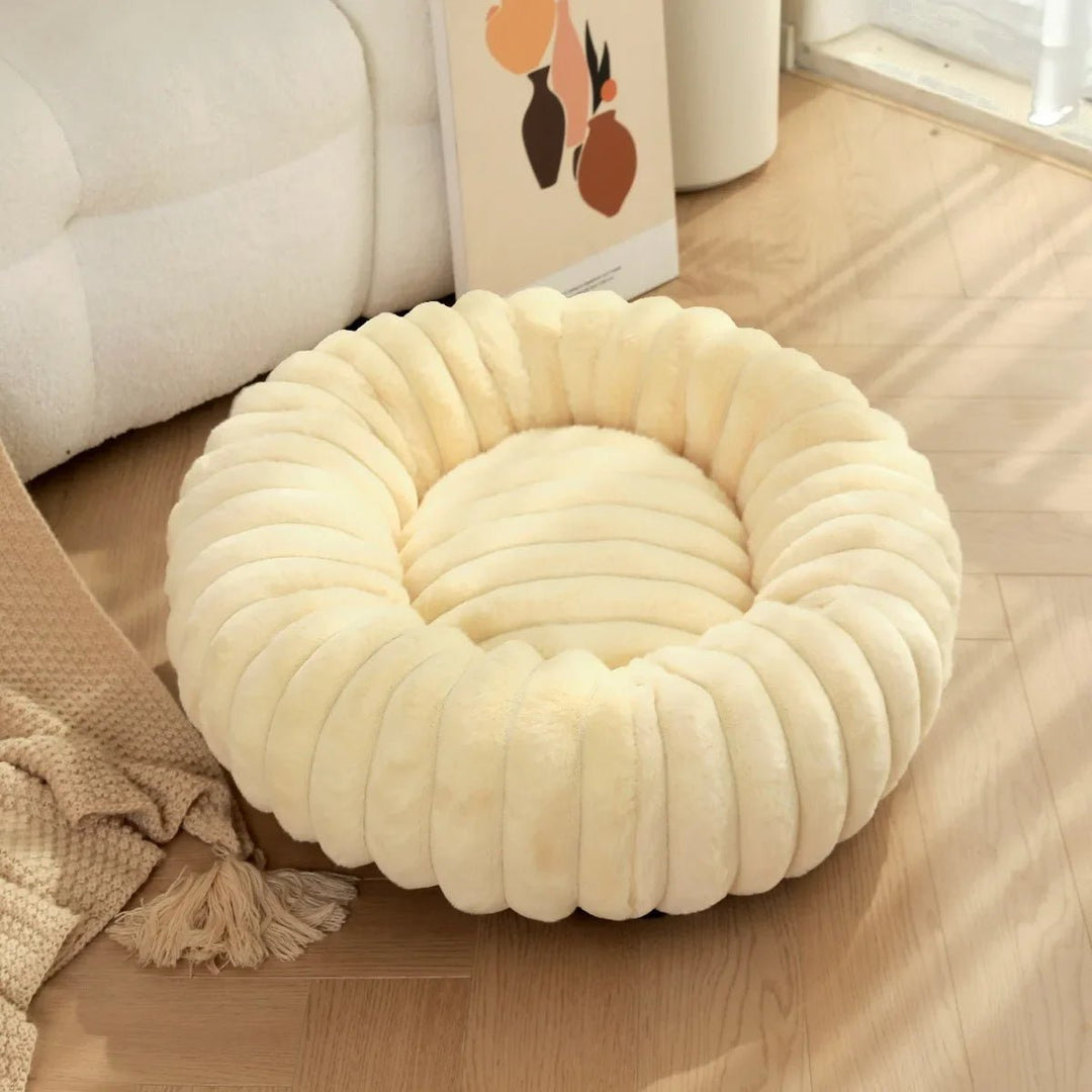 Plush donut calming dog bed in a neutral tone, perfect for small and medium pets.