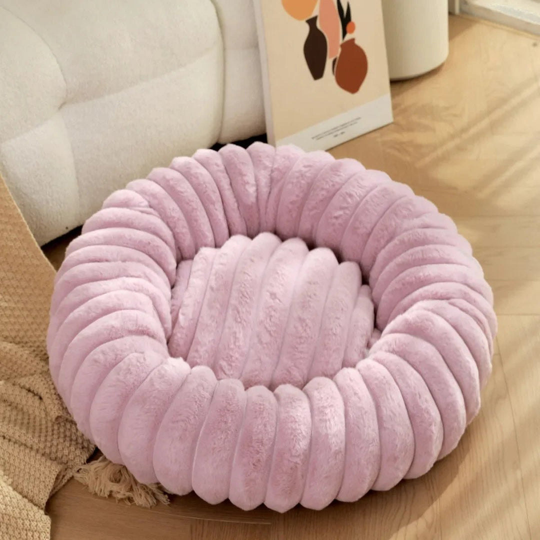 High-quality calming dog bed, donut style, designed for small dog relaxation and support.