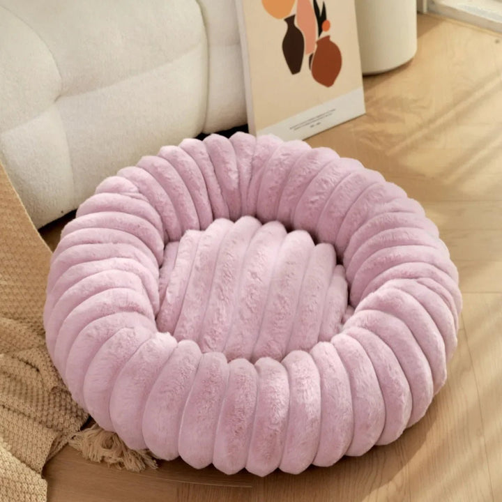 High-quality calming dog bed, donut style, designed for small dog relaxation and support.