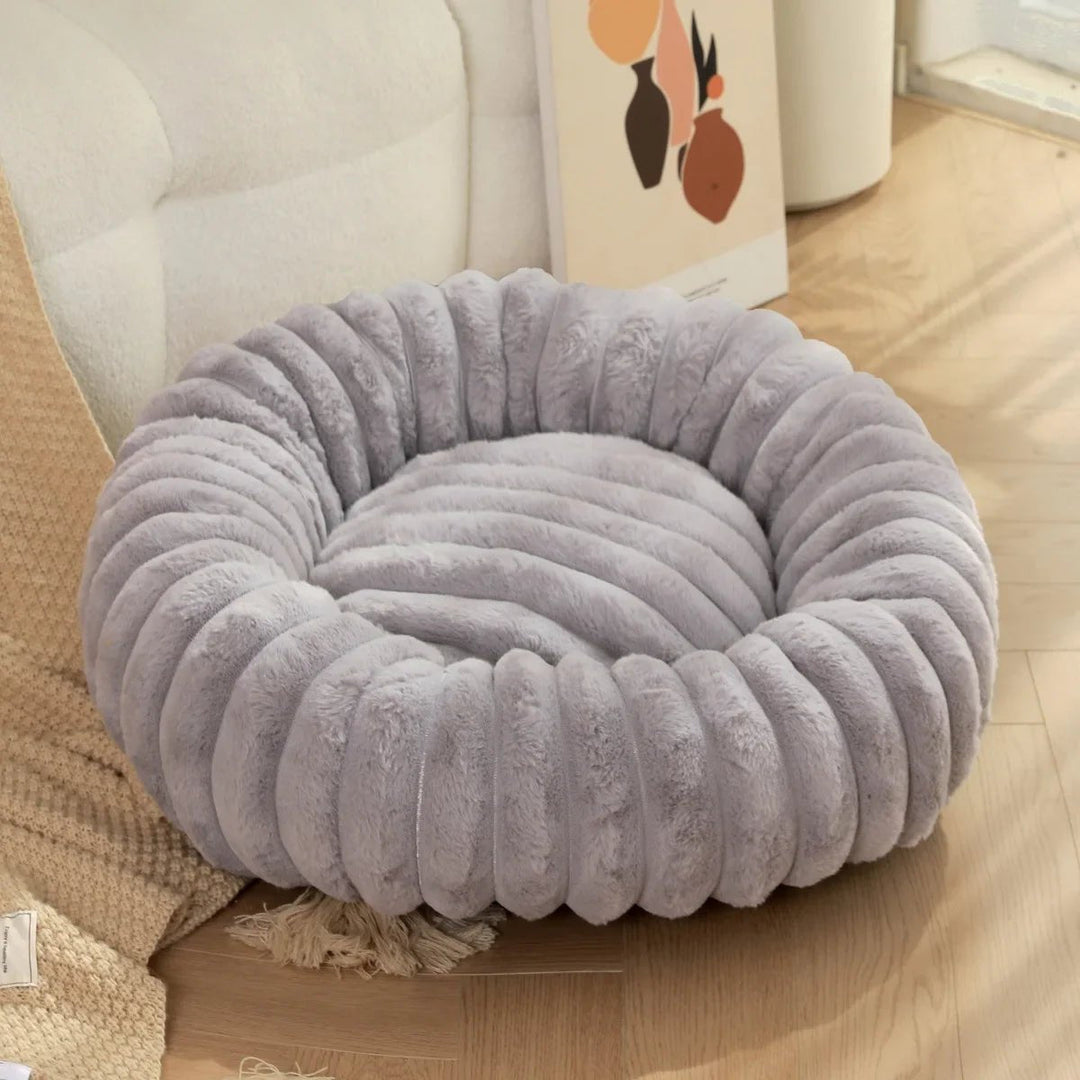 Deep sleep plush donut dog bed for small and medium pets, offering comfort and security.