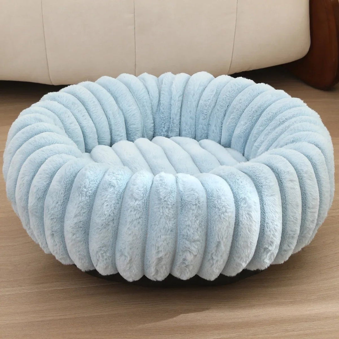 Brown plush donut dog bed, extra soft, creating a calming environment for small pets.
