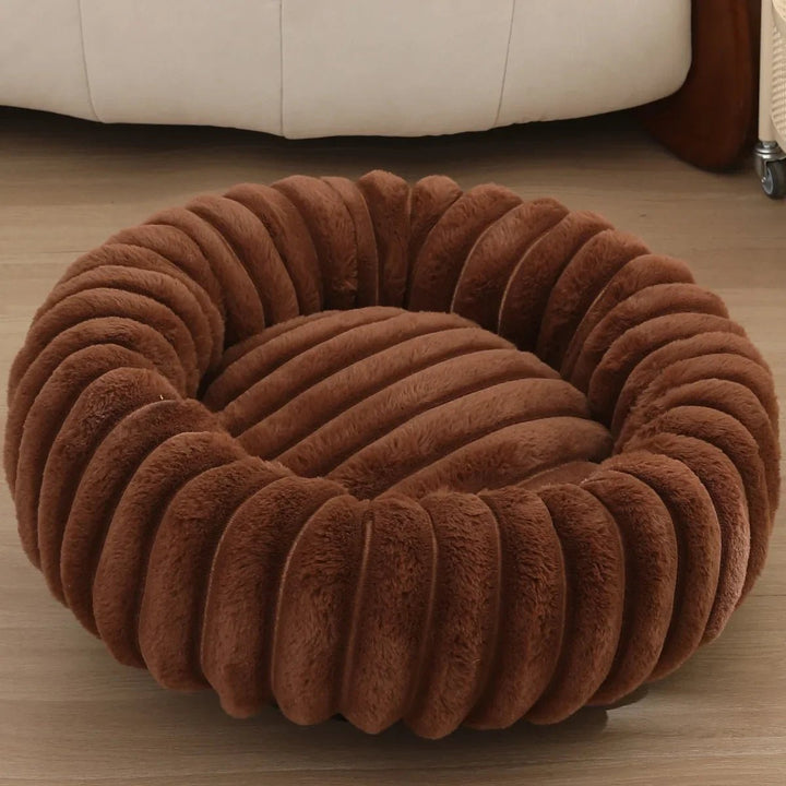 Donut-style pet bed for small to medium dogs, made with premium washable plush.