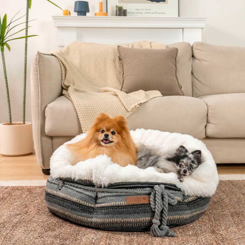 Soft jacquard donut dog bed, washable in a pale beige, for small dogs.
