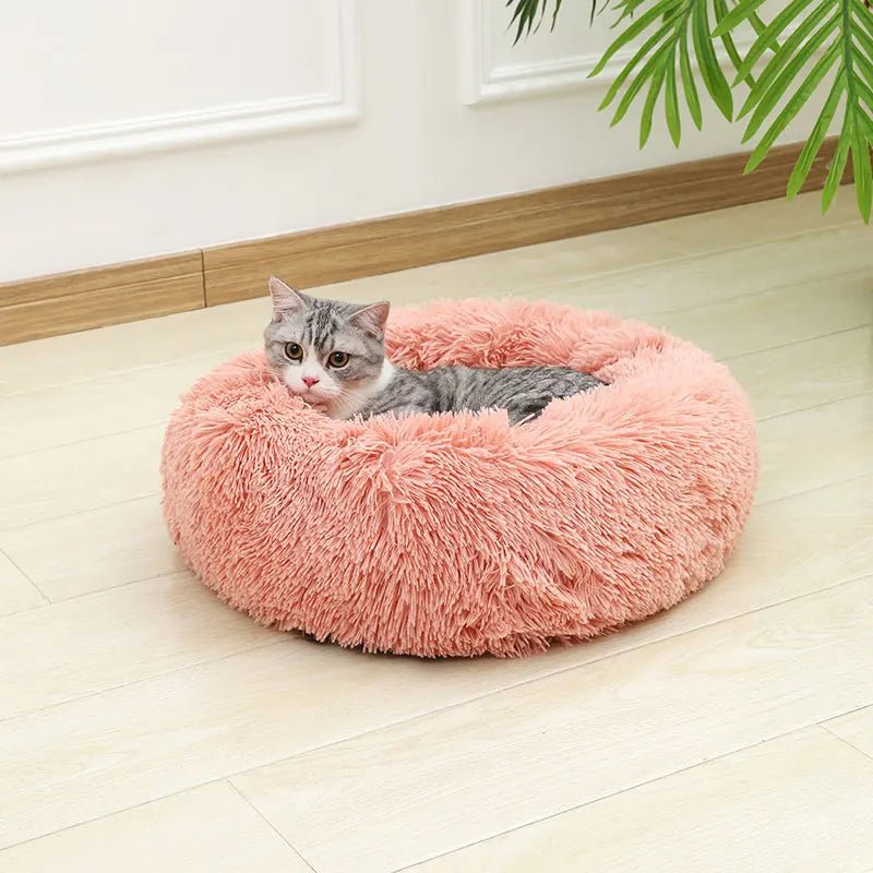 Luxury plush cat bed, donut shaped, providing warmth and security for pets