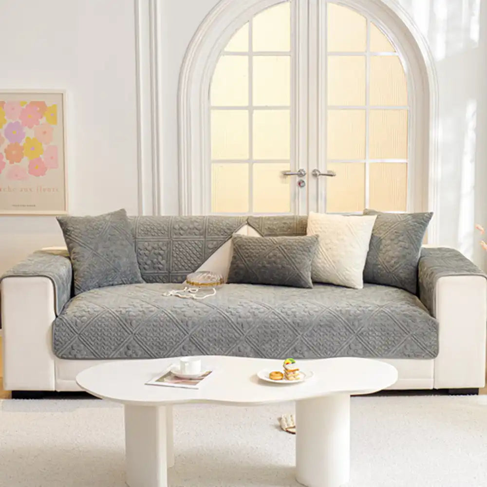 Soft quilted sofa cover with geometric pattern, pet-friendly, non-slip backing for furniture.