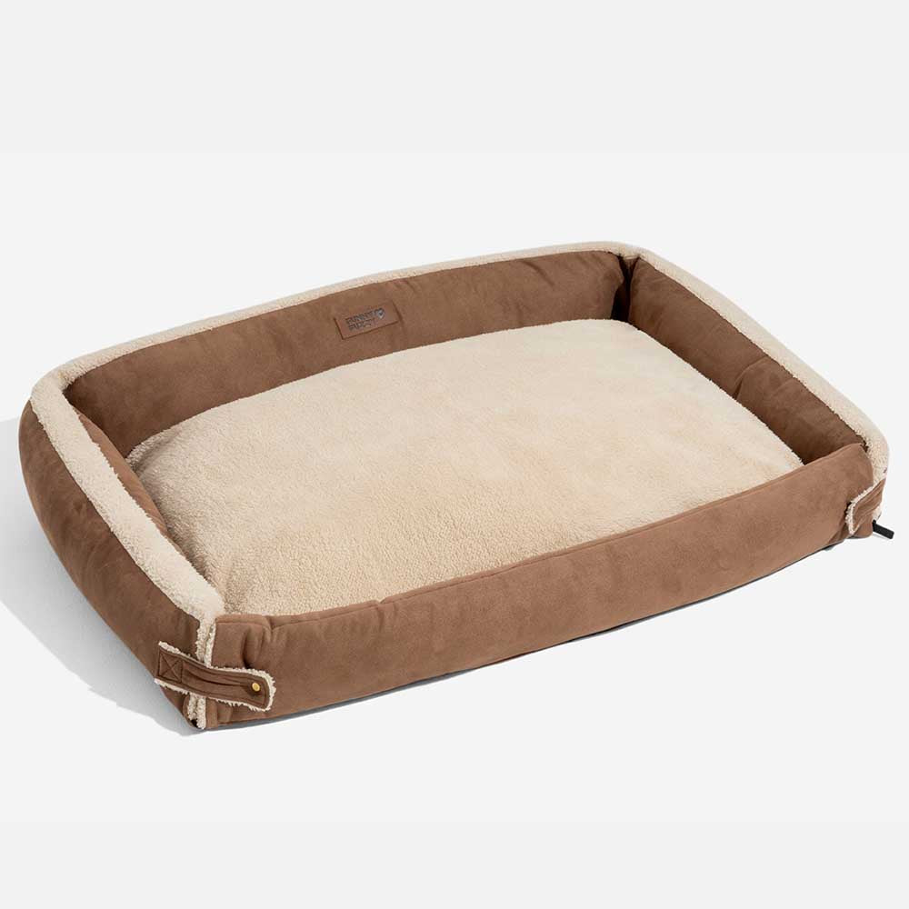 Washable cover being removed from an ergonomic dog bed for easy cleaning