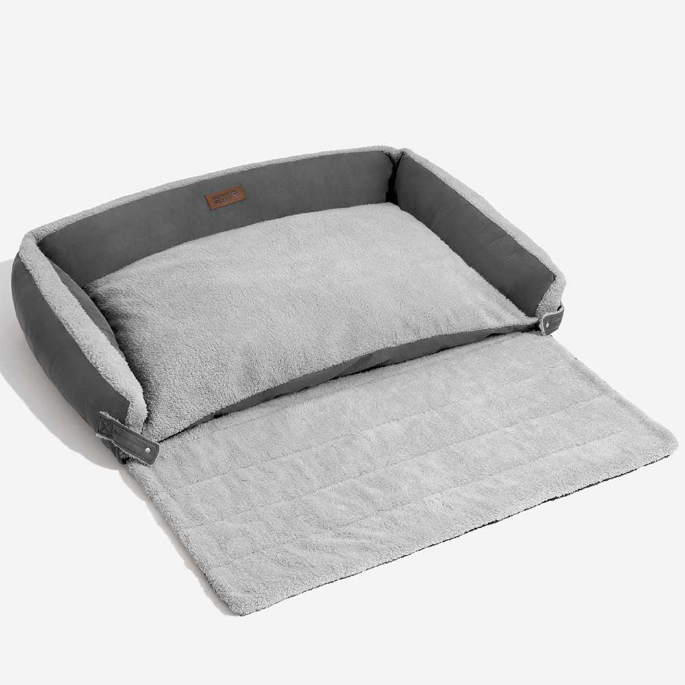Happy dog asleep on the plush, ergonomic expandable calming dog bed