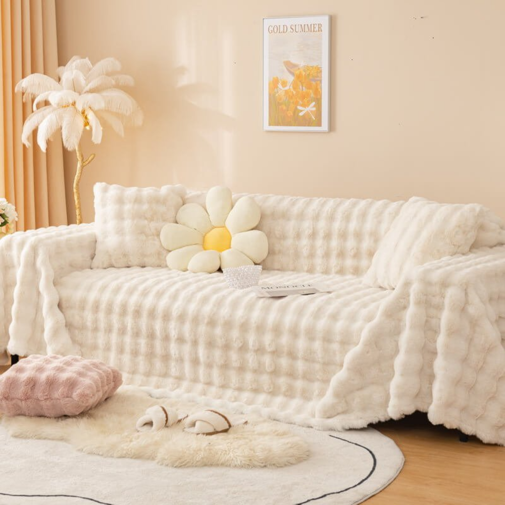 Plush faux fur sofa cover in a neutral tone, protecting living room furniture from pets and spills