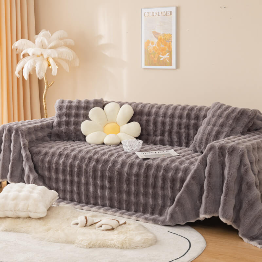 Soft faux fur slipcover draped over a sofa, adding pet-friendly comfort and elegant home decor