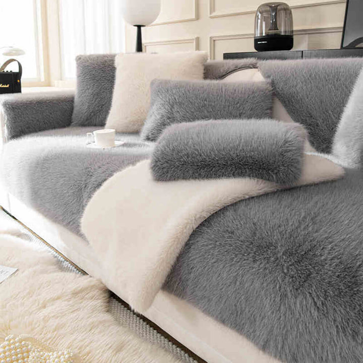 Non-slip backing of a plush faux fur sofa protector, ensuring it stays in place on furniture.