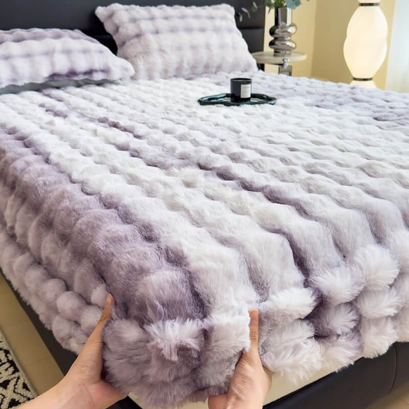 Close up of brushed faux rabbit fur on a gray fitted mattress protector