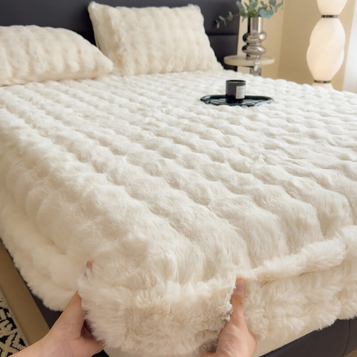 Cream faux rabbit fur fitted mattress protector, easy care bedding on a bed