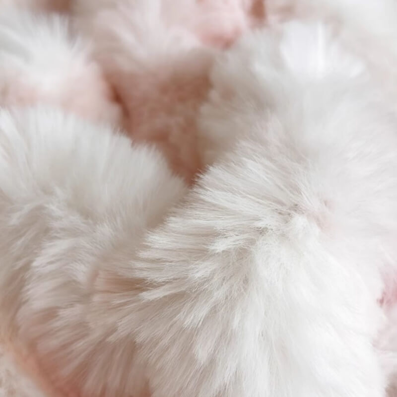 Bedroom setup with a luxurious faux fur mattress protector as a focal point