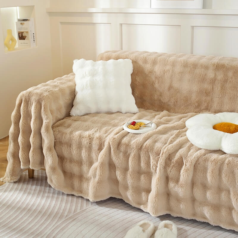 Modern home decor featuring a soft faux rabbit fur sofa cover, offering comfort and style.