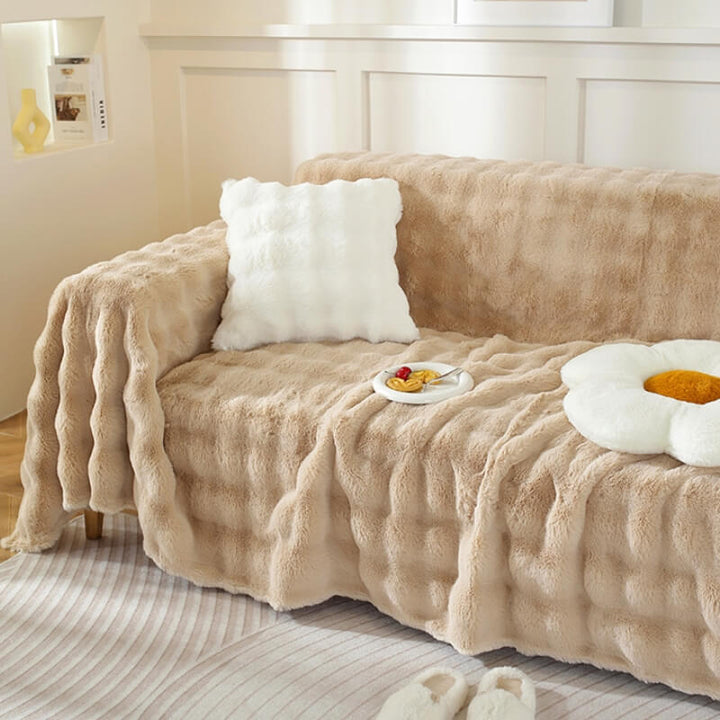 Modern home decor featuring a soft faux rabbit fur sofa cover, offering comfort and style.