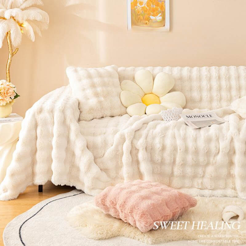 Close-up of the luxurious faux rabbit fur texture of a sofa cover, emphasizing its plush feel.