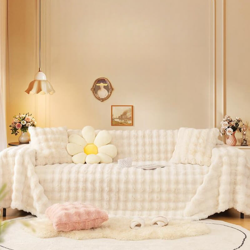 Washable faux rabbit fur sofa protector, perfect for homes with pets, shown installed on a couch.