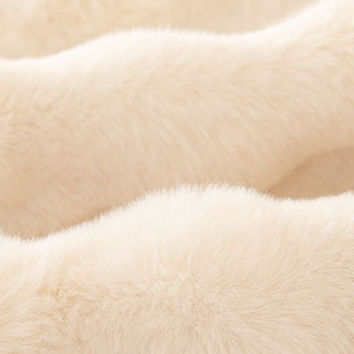 Stylish faux rabbit fur couch cover transforming a sofa, providing both comfort and furniture protection.