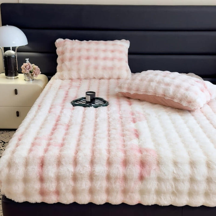 Plush faux rabbit mattress protector fitted sheet in a neutral color, enhancing bedroom comfort