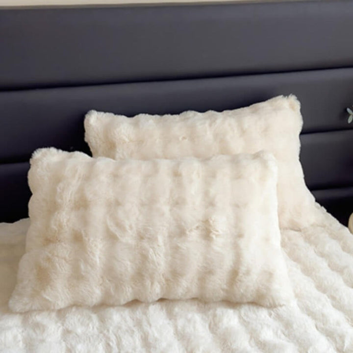 Fitted faux rabbit plush mattress protector sheet, adding a layer of comfort to bedding