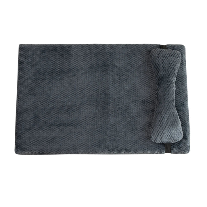 Unisex calming pet bed, a plush fleece mat with pillow for dog and cat anxiety relief.