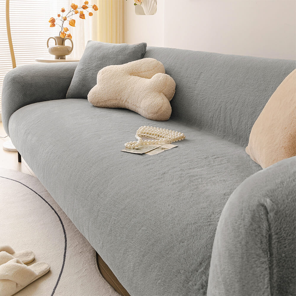 Elastic fit sofa slipcover made from plush, skin-friendly material, perfect for living room couch protection.
